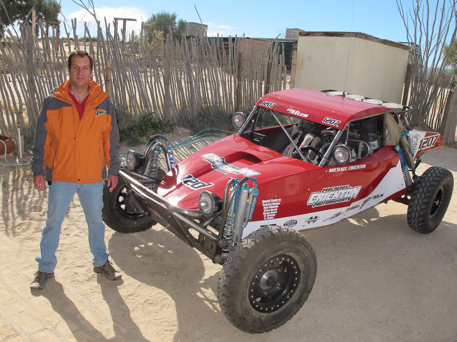 Michael Crichton aka Baja Moose in San Felipe standing next to his race buggy