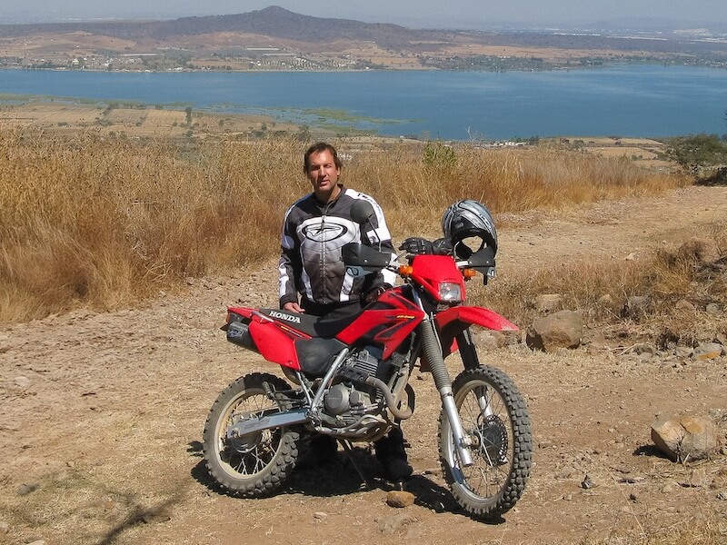 Baja Moose standing behind his Honda XR250 Tornado dual sport motorcycle